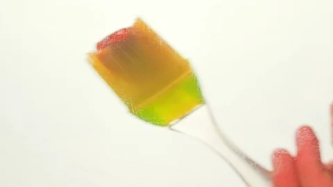 View from below as a cooking brush smears ketchup with herbs for cooking steak Stock Footage 122625051