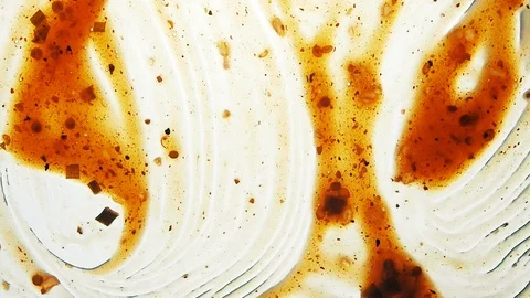 View from below as a cooking brush smears ketchup with herbs for cooking steak Stock Footage 122626830