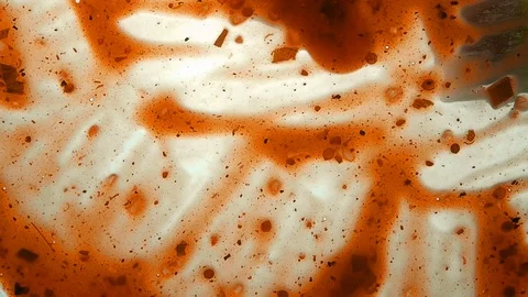 View from below as a cooking brush smears ketchup with herbs for cooking steak Stock-Footage 122640575