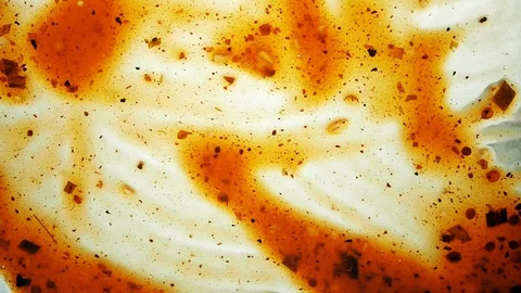 View from below as a cooking brush smears ketchup with herbs for cooking steak Stock Footage 122642578
