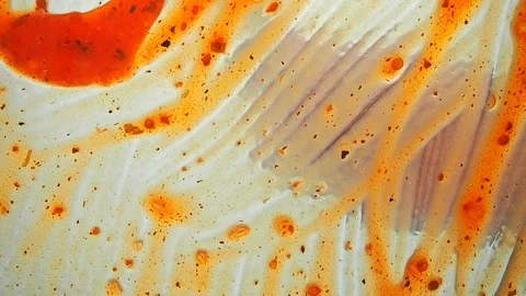 View from below as a cooking brush smears ketchup with herbs for cooking steak Stock Footage 122645831