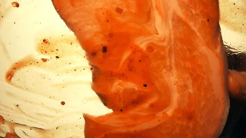 View from below as a cooking brush smears ketchup with herbs for cooking steak Stock-Footage 122652542