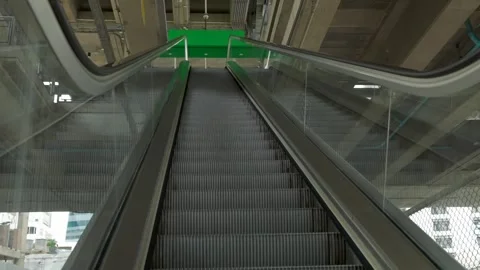 View from below of empty escalator with slow moving down steps from elevated Stock Footage 255053472