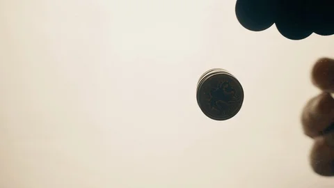 View from below as the hand throws gold coins. Moves them, collects them in the Stock Footage 122608633