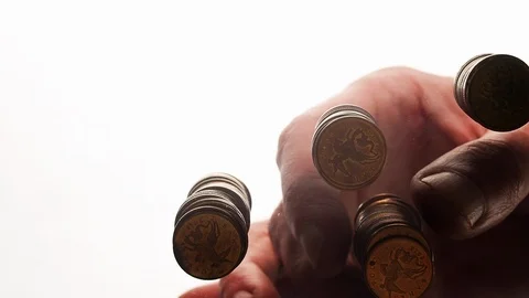 View from below as the hand throws gold coins. Moves them, collects them in the Stock Footage 122609334