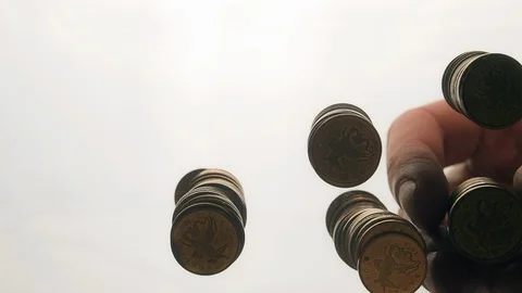 View from below as the hand throws gold coins. Moves them, collects them in the Stock Footage 122609467