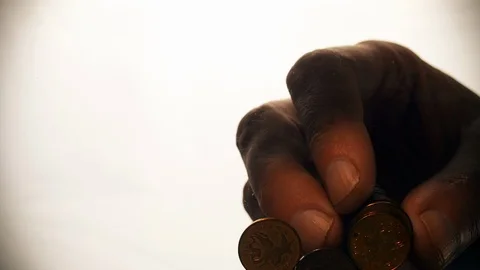 View from below as the hand throws gold coins. Moves them, collects them in the Stock Footage 122609913