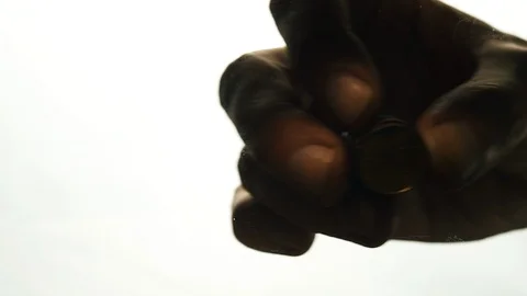 View from below as the hand throws gold coins. Moves them, collects them in the Stock Footage 122610277