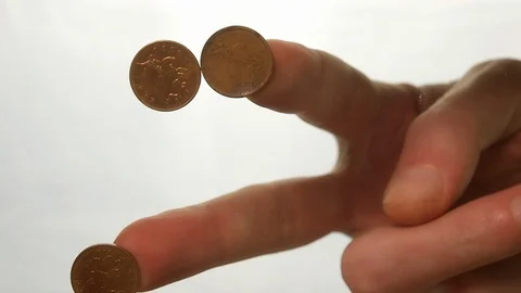 View from below as the hand throws gold coins. Moves them, collects them in the Stock Footage 122611386