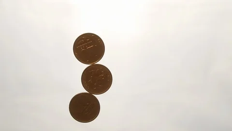 View from below as the hand throws gold coins. Moves them, collects them in the Stock Footage 122612497