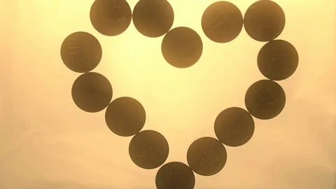 View from below as the hand throws gold coins. Moves them, collects them in the Stock Footage 122613623