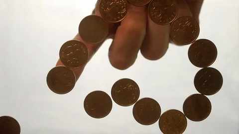 View from below as the hand throws gold coins. Moves them, collects them in the Stock-Footage 122617439
