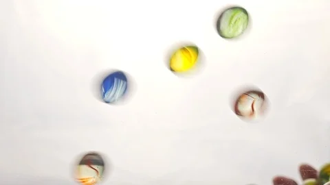 View from below as the hand throws small multi-colored colored plastic balls Stock Footage 122599331