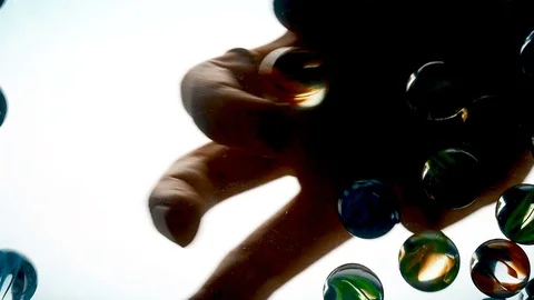 View from below as the hand throws small multi-colored colored plastic balls Stock Footage 122607997