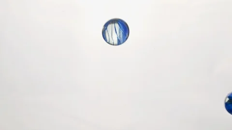 View from below as the hand throws small Blue colored plastic balls. White Stock Footage 122608463