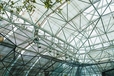 A view from below highlights the steel framework of a building, with light co 写真素材