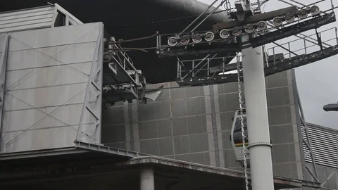 View from below of metrocable cabins entering and leaving the San Javier station Stock Footage 91555869