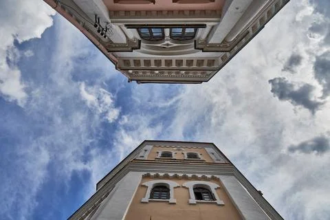 A view from below of an old red brick water tower against a background of clo Stock Photos