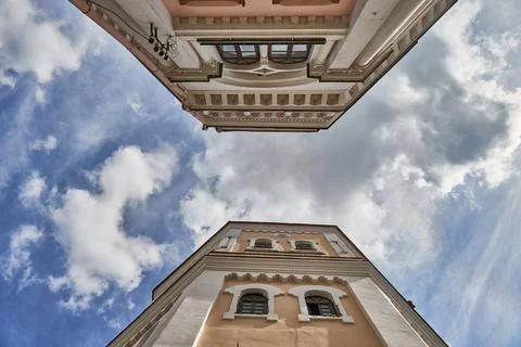 A view from below of an old red brick water tower against a background of clo Stock Photos