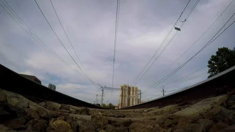A view from below on the railway tracks and russian suburban train approaching Vidéo 121048827