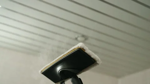 View from below of steam mop with microfiber pad applying hot vapor to ceiling Stock Footage 318749839