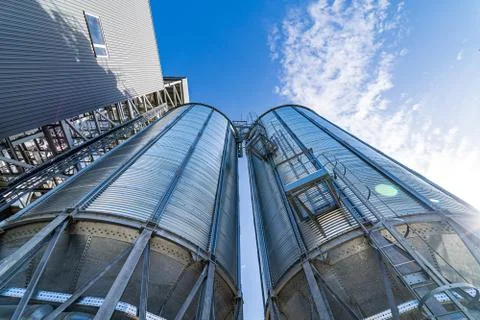 View from below on steel grain elevators. Modern up to date factory. Selectiv Stock Photos