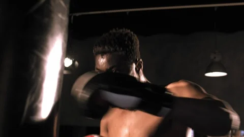 View from below strong-willed african-american boxer intensely boxing Stock Footage 112924686