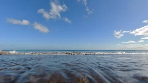 A view from below of the surf on an Atlantic Ocean beach under a blue sky. Stock-Footage 328371622