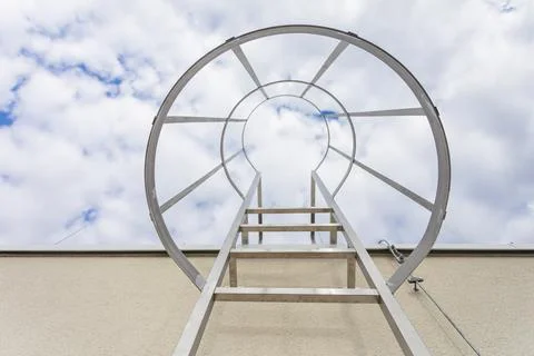 View from below of the technical ladder leading to the building's roof. Stock-Fotos