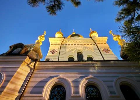 View from below upwards to the facade of the cathedral with gold-casting dome Stock Photos