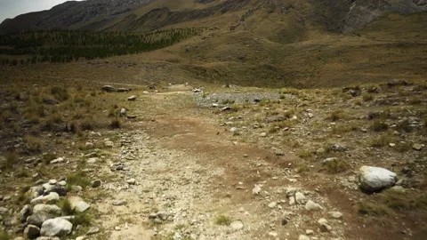 View from below walking through a trek on a path of stones and dirt hoping to Stock Footage 164597342