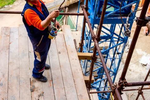View below on worker who is preparing hooks for cargo Stock Photos