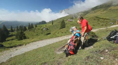 View on bench in mountains with hikers Stock Footage 525225