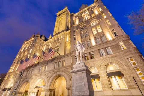 View of Benjamin Franklin statue and US flags in front of former Old Post Office Stock Photos