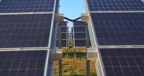 View between aligned solar panels capturing powerful clean energy on site Stock Footage 302279842