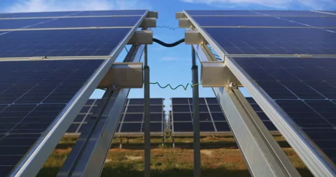 View between aligned solar panels capturing powerful clean energy on site Video stock 302279963