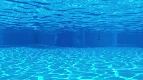 The view between bottom and surface of swimming pool blue water, sun reflections Stock Footage 163180044