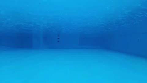 The view between bottom and surface of swimming pool blue water during the rain Stock Footage 163180191