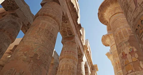 Up view between the engraved stone pillars of Luxor temple Stock Footage 299080091