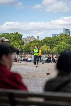 View between out of focus heads of a man wearing a hi-vis jacket on South Bank Stock Photos