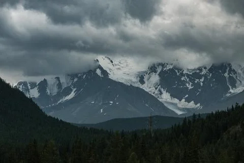 View beyond the snow-capped peaks of the mountains near Aktash in the Altai R Stock Photos
