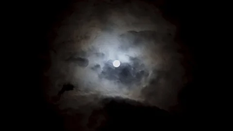 View of bif full moon on night sky. White moon between volume cumulus clouds. Stock Footage 108016775