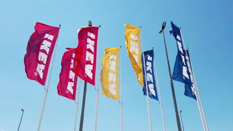 View of big colorful Ikea flags on blue sky Stock Footage 135460329