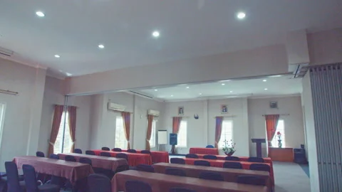 A View of Big Conference Room With Red Covered Tables and Black Chairs Stock Footage 162028908