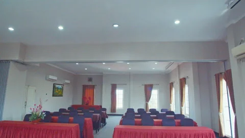 A View of Big Conference Room With Red Covered Tables and Black Chairs Stock Footage 162029011