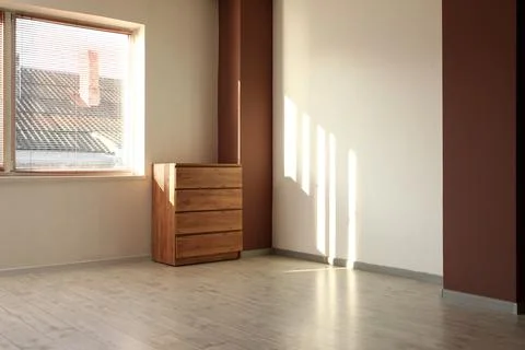 View of big empty room with commode and window Stock Photos