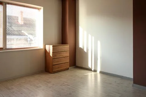 View of big empty room with commode and window Stock Photos