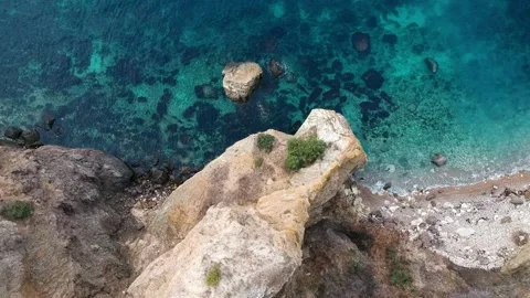 The view from the bird's eye view on the steep coast with crystal clear turqu Stock Footage 131801679
