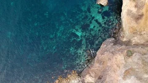 The view from the bird's eye view on the steep coast with crystal clear turqu Stock Footage 131801683