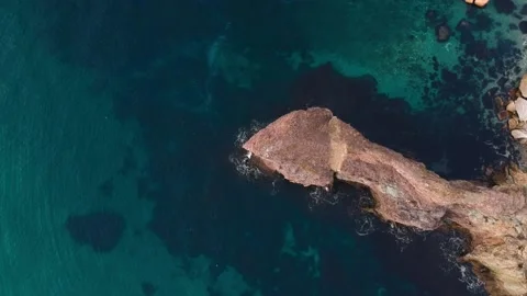 The view from the bird's eye view on the steep coast with crystal clear turqu Stock Footage 131801698